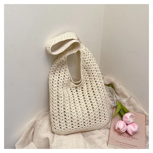 Detailed close-up of handmade crochet texture on beige woven tote bag for casual commute