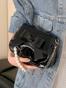 French style black patent leather crossbody bag with bow, pearl handle, and chain strap