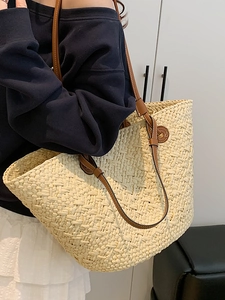 Large straw tote bag with brown leather straps for stylish summer seaside beach vacations