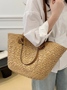 Straw woven tote bag with brown leather straps for beach holidays and daily shopping