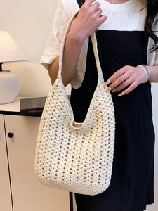 Chic woven tote bag in cream white with intricate openwork crochet for casual beach style