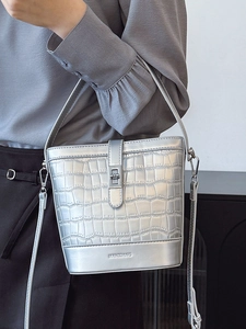 Silver crocodile pattern bucket bag with metallic finish and adjustable shoulder strap
