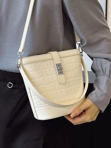 Minimalist creamy stone pattern bucket bag with silver metal lock and crossbody strap