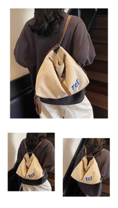 Detail showing versatile canvas tote bag with leather trim and blue TCT embroidery detail