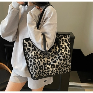 Close-up of high-capacity leopard print tote bag with reinforced black shoulder straps