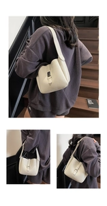 Close-up of beige lychee grain leather bucket bag with metal buckle and wide shoulder strap