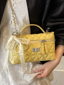Bright yellow quilted chain bag with elegant pearl lace bow charm for women