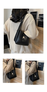 Detailed view of black lychee grain leather bucket bag with silver metal buckle closure