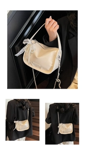 Detail of cream leather pillow bag featuring lace bow, pearl chain and silver metal logo
