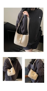 Detail showing the adjustable shoulder strap and lychee grain leather of the beige bucket bag