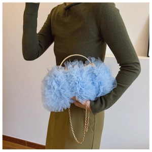 Detail of light blue mesh tulle handbag with floral ruffles and gold circular handle