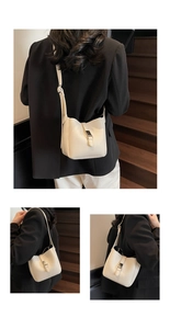 Detail shot of beige lychee texture bucket bag with metal buckle and shoulder strap