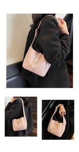 Close-up of pink lychee textured leather bucket bag with silver metal buckle and long strap