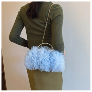 Detailed back view of a light blue tulle crossbody bag with golden metal ring handle