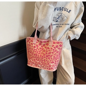 Close-up of pink and orange leopard print canvas tote bag with pink shoulder straps