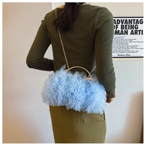 Lace mesh handbag with gold ring handle and chain strap shown in a fashion lifestyle setting