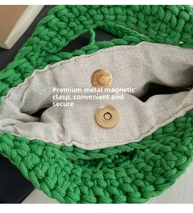 Close-up of green woven handbag featuring a golden magnetic clasp and cotton lining