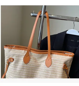 Detailed macro view of woven straw texture and premium brown leather straps on tote bag