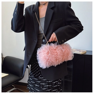 Detailed shot of pink pleated lace mesh crossbody bag with gold chain and metal handle