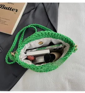 Detail of hand-woven green tote bag with magnetic closure and inner lining