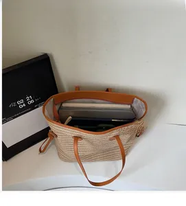 Top view of large straw tote bag interior showing ample space for a laptop and books