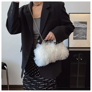 Detail of white lace mesh handbag with golden round metal handle and fine chain strap