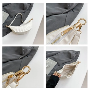 Detailed views of white crescent shoulder bag showing gold zipper and interior storage space