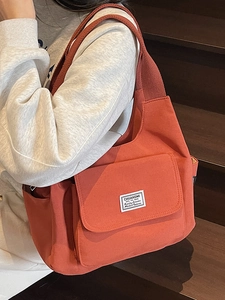 Orange red canvas messenger bag with large flap pocket and adjustable strap