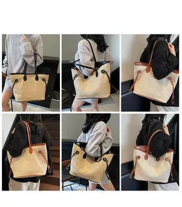 Detail view of large straw tote bag featuring leather trim and side drawstring design