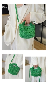 Close-up of vibrant emerald green woven handbag showing detailed knit texture and straps