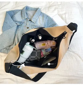 Spacious beige nylon dumpling bag interior showing large capacity for travel essentials