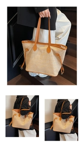 Detail of a large straw tote bag with brown faux leather trim and adjustable side straps