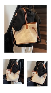 Close-up detail of a straw tote bag featuring brown faux leather trim and drawstring accents