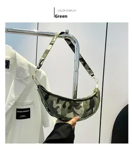 Detail of green camouflage crescent shoulder bag with durable fabric and metal zippers