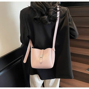Pink lychee texture bucket bag on a model showing daily crossbody style and size