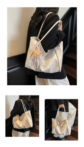 Detailed view of cream soft leather tote bag featuring a cute plush bear pendant accessory