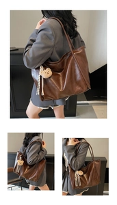 Detailed close-up of dark brown faux leather tote bag with plush bear charm and tassel
