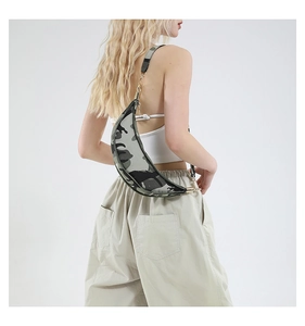 Detailed view of camouflage crescent bag with adjustable strap and metallic hook