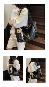 Three-way view of a large black leather tote bag with a cute bear charm on stairs