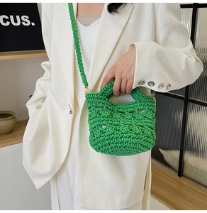 Detailed close-up of a vibrant green hand-woven crochet bag with premium knit texture