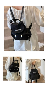 Detail of black nylon backpack featuring colorful MeaRey embroidery and braided handle