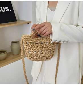 Close-up of handmade hollow woven bucket bag with intricate crochet texture and handle