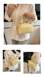 Detail view of cream yellow bowling handbag showing smooth texture and detachable strap