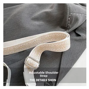 Detail of adjustable beige jacquard woven strap with silver buckle and geometric pattern