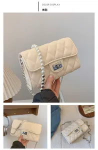 Détail du sac bandoulière matelassé blanc cassé avec perles élégantes et poignée en chaîne