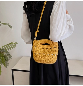 Detail of yellow handwoven crochet bag featuring hollow textures and sturdy shoulder strap