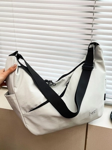 Minimalist large capacity nylon crossbody bag with wide adjustable strap in light grey