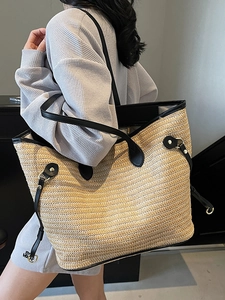 Contrast straw tote bag with black leather trim and handles for summer casual fashion