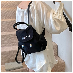 Detail of black nylon mini backpack with colorful MeaRey logo and beaded drawstring decor