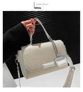 White commuter crossbody bag with woven texture, silver chain charm and ethnic wide strap
